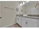Clean bathroom with double vanity, gray countertop, and white cabinets at 840 Pebble Beach Dr, Davenport, FL 33896