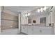 Double vanity bathroom with a bathtub and shower at 840 Pebble Beach Dr, Davenport, FL 33896