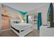 Bright bedroom with beach mural, teal curtains, and a flat-screen TV at 840 Pebble Beach Dr, Davenport, FL 33896