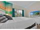 Beach-themed bedroom with a comfortable bed and ocean view mural at 840 Pebble Beach Dr, Davenport, FL 33896
