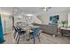 Open concept dining area with seating for six and view of living room at 840 Pebble Beach Dr, Davenport, FL 33896