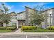 Contemporary townhome with a gray facade and neatly manicured landscaping at 840 Pebble Beach Dr, Davenport, FL 33896
