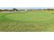Putting green with a flag and water feature at 840 Pebble Beach Dr, Davenport, FL 33896