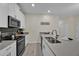 Modern kitchen with stainless steel appliances and an island at 840 Pebble Beach Dr, Davenport, FL 33896