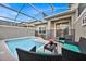 Relaxing pool and patio area with seating and privacy at 840 Pebble Beach Dr, Davenport, FL 33896