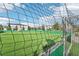 Artificial turf soccer field, enclosed by netting at 840 Pebble Beach Dr, Davenport, FL 33896