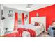 Vibrant bedroom with red accent wall and a comfortable bed at 1087 Welch Hill Cir, Apopka, FL 32712