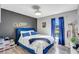 Cozy bedroom with a blue velvet bed, decorative wall art, and a window at 1087 Welch Hill Cir, Apopka, FL 32712
