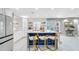Modern kitchen with white cabinets, blue island, and gold barstools at 1087 Welch Hill Cir, Apopka, FL 32712