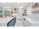 Modern kitchen with white cabinets, quartz countertops, and stainless steel appliances at 1087 Welch Hill Cir, Apopka, FL 32712