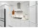 Modern kitchen features white cabinets, stainless steel appliances, and a quartz countertop at 1087 Welch Hill Cir, Apopka, FL 32712
