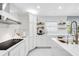 Modern kitchen with white cabinets, quartz countertops, and a large island at 1087 Welch Hill Cir, Apopka, FL 32712