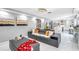 Spacious living room with gray sectional sofa and view of kitchen at 1087 Welch Hill Cir, Apopka, FL 32712