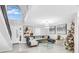 Bright living room with sectional sofa, glass coffee table, and decorated Christmas tree, plus high ceilings at 1087 Welch Hill Cir, Apopka, FL 32712