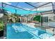 Inviting pool area with a covered patio and lush landscaping at 1087 Welch Hill Cir, Apopka, FL 32712