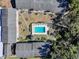 Community pool area surrounded by lush greenery and condo buildings at 110 N Tremain St # 110, Mount Dora, FL 32757