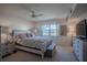 Inviting bedroom with wooden furniture, ceiling fan, and ample natural light at 110 N Tremain St # 110, Mount Dora, FL 32757