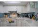 Updated kitchen with white cabinets, blue tile backsplash, and modern appliances at 110 N Tremain St # 110, Mount Dora, FL 32757
