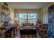 Bright room with wood floors, comfy seating, and a large window at 110 N Tremain St # 110, Mount Dora, FL 32757