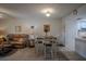 Cozy living and dining area with a ceiling fan, comfortable seating, and an adjacent kitchen at 110 N Tremain St # 110, Mount Dora, FL 32757