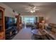 Spacious living room with large windows, comfortable seating, and an entertainment center at 110 N Tremain St # 110, Mount Dora, FL 32757