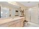 Bathroom with shower, vanity and decorative accents at 1201 De La Fuente Ct, The Villages, FL 32162