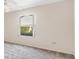 Spacious bedroom with grey carpet and large window at 1201 De La Fuente Ct, The Villages, FL 32162