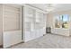 Bedroom with built-in white shelving and a murphy bed at 1201 De La Fuente Ct, The Villages, FL 32162