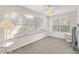 Bright bedroom with window blinds, ceiling fan, and carpet flooring at 1201 De La Fuente Ct, The Villages, FL 32162