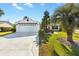 House exterior with driveway, landscaping, and garage at 1201 De La Fuente Ct, The Villages, FL 32162