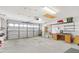 Garage with work bench and ample storage shelving at 1201 De La Fuente Ct, The Villages, FL 32162