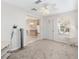 Living room with view into kitchen and access to exterior at 1201 De La Fuente Ct, The Villages, FL 32162