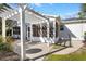 White pergola and patio with access to sunroom at 1201 De La Fuente Ct, The Villages, FL 32162
