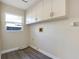 Laundry room with upper cabinets, vinyl flooring and a window at 130 Frosti Way, Eustis, FL 32726