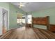 Bedroom with wood flooring and sliding doors leading to a patio at 1442 Almanza Dr, The Villages, FL 32159