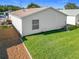 Rear view of house showing lawn and ac unit at 17439 Se 93Rd Vine Ave, The Villages, FL 32162