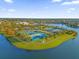 Aerial view of community amenities including tennis courts and a lake at 1974 Wallingford Loop, Mount Dora, FL 32757