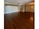 Large living room with hardwood floors and a built-in entertainment center at 21152 Braveheart Dr, Leesburg, FL 34748