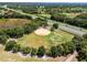 An aerial view showcasing a baseball field nestled within a tree-lined landscape at 26655 Evert St, Leesburg, FL 34748