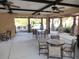 Covered patio area with tables and chairs near the pool at 26934 Camerons Run, Leesburg, FL 34748