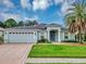 Single-Gathering home with two-car garage and palm tree at 26934 Camerons Run, Leesburg, FL 34748