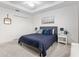 Bedroom featuring a blue upholstered bed, white walls, and closet doors at 3974 Towana Loop, The Villages, FL 32163