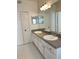 Spacious bathroom featuring double sinks, white cabinetry, and tiled flooring at 420 Summit Ridge Pl # 214, Longwood, FL 32779