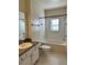 Clean bathroom with white cabinets, a bathtub, and tiled floors at 420 Summit Ridge Pl # 214, Longwood, FL 32779
