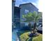 Front exterior view of the condo building with stairs leading to the upper units and lush landscaping at 420 Summit Ridge Pl # 214, Longwood, FL 32779