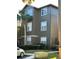 View of the building's exterior with gray siding, white windows, and a palm tree at 420 Summit Ridge Pl # 214, Longwood, FL 32779