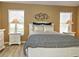 Spacious bedroom with a queen-size bed, nightstands, and ample natural light at 5032 St. Andrews Arc, Leesburg, FL 34748