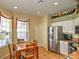 Kitchen with stainless steel refrigerator and breakfast nook at 5032 St. Andrews Arc, Leesburg, FL 34748