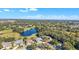 Aerial view of neighborhood with lake and golf course at 5060 Greenbriar Trl, Mount Dora, FL 32757