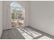 Well-lit bedroom with large arched window and plush carpeting at 5060 Greenbriar Trl, Mount Dora, FL 32757